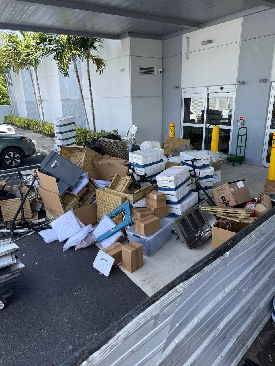 Boxes, shelving and bins piled outside a commercial building for cleanout